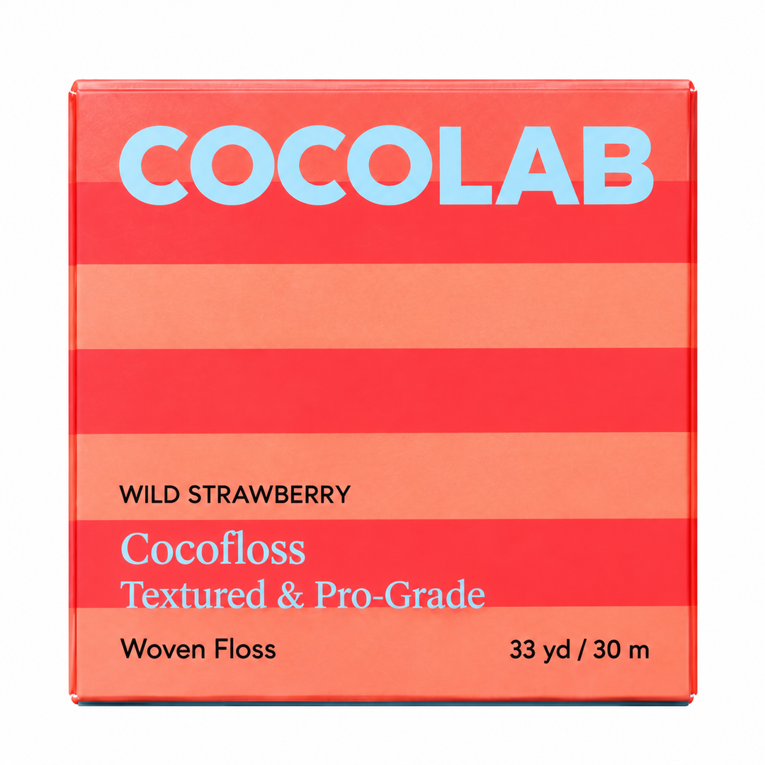 Blue Cocofloss pulled taut to show the flat woven ribbon and its vegan wax coating